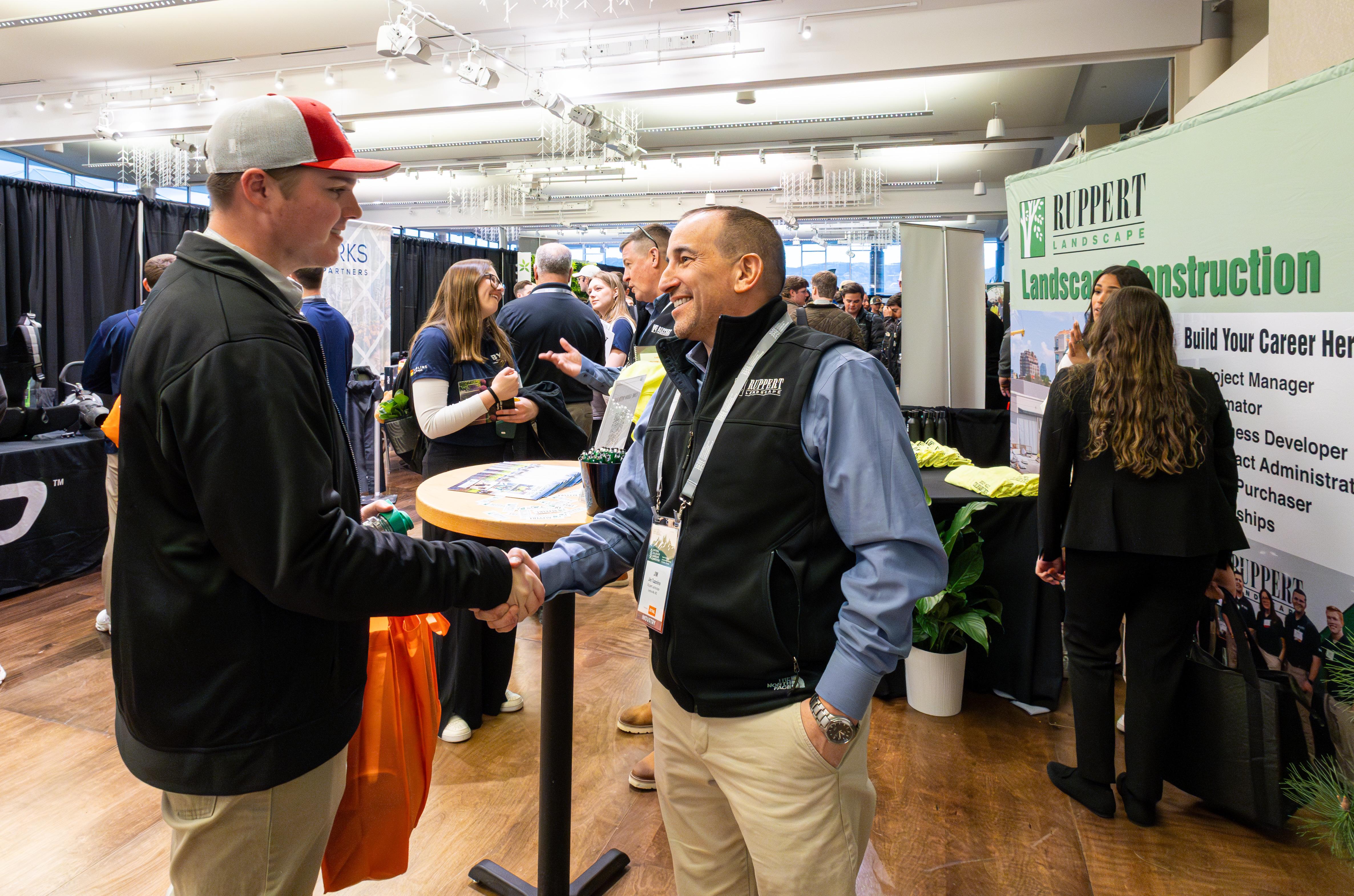 student shaking hands with professional at the nclc career fair